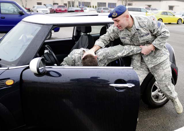 Marco Lorenz, a civilian security forces instructor assigned to the 86th Security Forces Squadron, demonstrates how to forcefully remove someone from a vehicle during a Tactical Combatives Course Feb. 12 on Ramstein.