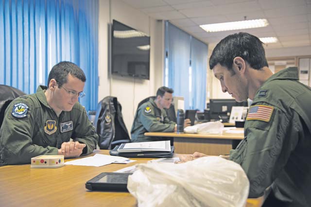 First Lt. Robert Stephenson and Capt. Kenneth Jubb, 37th Airlift Squadron pilots, go over mission planning Jan. 22 on Ramstein. The intent of the mission was to train the pilots in flying at 7,000 feet and performing a simulated cargo drop to maintain proficiency.