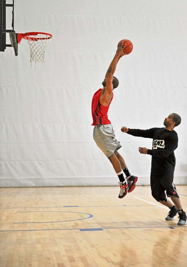 Master Sgt. David Allen, 24th Intelligence Squadron unit training manager, catches a rebound during the basketball competition Feb. 14 on Ramstein. Allen had been eliminated earlier in the competition, but used a $20 Army and Air Force Exchange Service gift card consolation prize to buy back into the game.