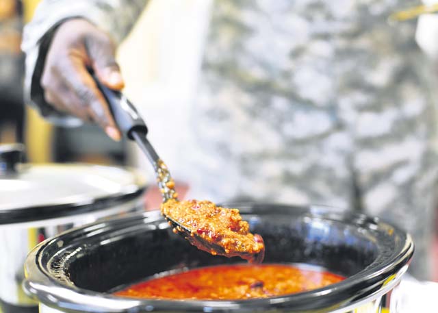Command Sgt. Maj. Brian K. Mainor, 21st Theater Sustainment Command’s  21st Special Troops Battalion command sergeant major, holds up a spoon full of chili during the 21st STB annual chili cook-off Jan. 29 on Panzer Kaserne.