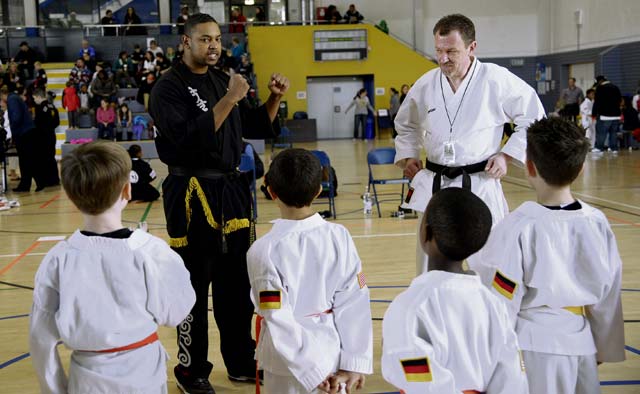 Travis Gentry (left), Kuk Sool Won instructor, and Manfred Bemme, Loveless Okinawan Karate Academy, explain the rules of the sparring division to participants during the 15th annual U.S. Air Forces in Europe martial arts tournament Feb. 28 at Ramstein. 