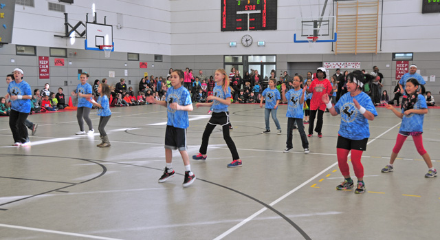 Photo by Heidi BuschKES is 'Happy'Kaiserslautern Elementary School student council members and their sponsors perform a half time routine to the song "Happy" during the KES students vs. staff basketball match.