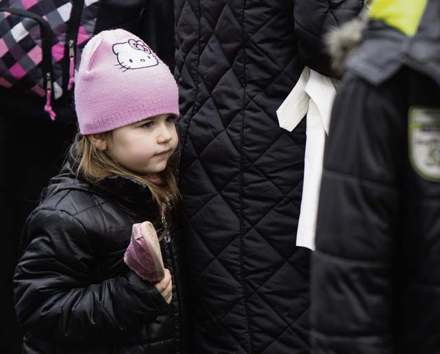 A child holds a shoe she found at a food and clothing drive Feb. 21 in Kaiserslautern.
