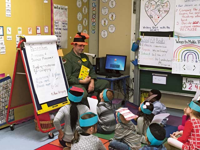 Courtesy photoTech. Sgt. Chris Vanwy, 603rd Air Operations Center, reads to Vogelweh Elementary School students on National Read Across America Day.  
