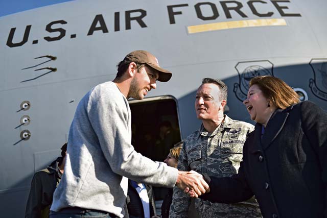 Photo by Staff Sgt. Sara KellerIndianapolis Colts quarterback Andrew Luck greets Brig. Gen. Patrick X. Mordente, 86th Airlift Wing commander, and his wife, Marissa, upon arrival at Ramstein.