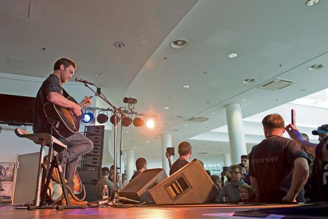 Photo by Senior Airman Damon KasbergPlatinum recording artist Phillip Phillips sings for military members and their families during the USO Spring Visit.