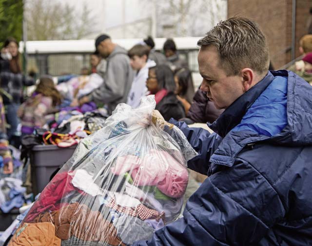 Maj. Matthew Boyd, 86th Airlift Wing chaplain, sorts clothing for the less fortunate during a donation event Feb. 21 in Kaiserslautern. Airmen from Ramstein Air Base worked alongside volunteers in the KMC to distribute clothing and food for the less fortunate. 