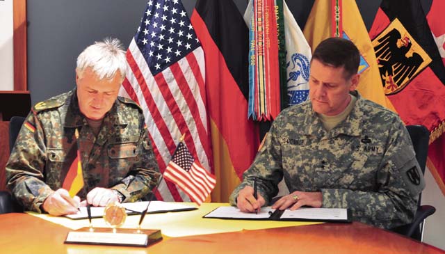 Photo by Ronnie SchelbyMaj. Gen. John O’Connor (right), commander of the 21st Theater Sustainment Command, and Maj. Gen. Hans Erich Antoni, commander of the Bundeswehr Logistics Command, sign a partnership memorandum between the two organizations March 5 on Panzer Kaserne.  This was the first formal renewal of the U.S.-German military logistics partnership in almost 20 years. 