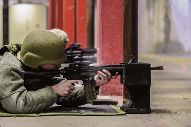Staff Sgt. Jason Stephan, 1st Combat Communications Squadron radio frequency transmission systems technician, fires an M-4 Carbine during a qualification test Feb. 23 at the KMC Combat Arms Training and Maintenance Squadron. 