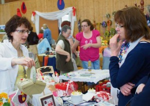 Visitors look at presents for Easter and decoration items for their homes at the Niederkirchen Easter market.