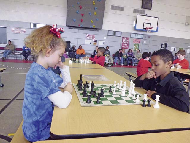 Kaiserslautern Elementary School third-graders, Kaylee Brown and Korey Lewis plan their next chess move. 