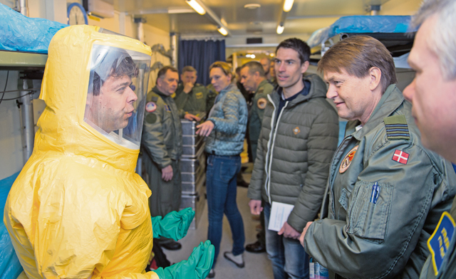 Two Royal Danish air force airmen discuss the aeromedical evacuation unit during a tour they provided to more than 200 aerospace medicine professionals March 11 at Ramstein. The Danish and 18 other nations participated in the 30th Ramstein Aerospace Medicine Summit and NATO Science and Technology Organization Technical Course.