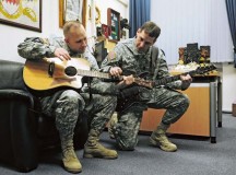 Photo by Brandon BeachSgt. Maj. Shawn M. Firch, 21st Theater Sustainment Command secretary general staff sergeant major, teaches Command Sgt. Maj. Rodney J. Rhoades, 21st TSC senior enlisted leader, how to play the guitar during some down time Feb. 22 on Panzer Kaserne.