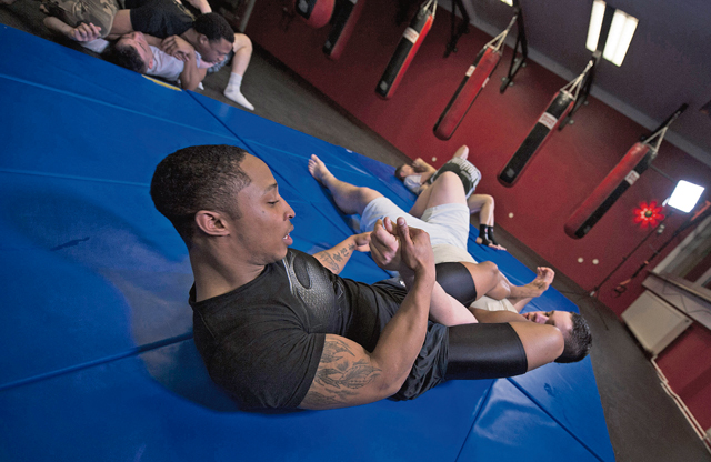 U.S. Army Spc. Forrest Powell (right), a vehicle mechanic assigned to the 51st Transportation Company, improves his mixed martial arts “arm-bar.”  Powell participates in MMA training with German nationals and American citizens in hopes of improving his skills as an MMA fighter.