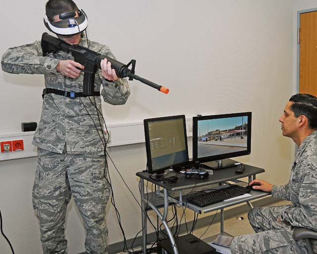 Photo by Phil A. JonesA behavioral health specialist aims his weapon during a demonstration provided by Maj. (Dr.) Michael Valdovinos to show how Virtual Reality Exposure Therapy can be used to treat Post-Traumatic Stress Disorder.