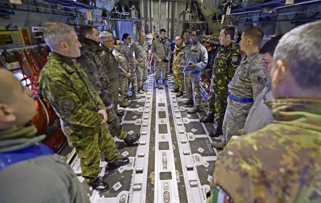 Tech. Sgt. James Shanks and Tech. Sgt. Chris Willingham, 86th Aircraft Maintenance Squadron, brief a group of enlisted leaders from six different nations’ air forces throughout Europe about the 86th AMXS’s mission inside a C-130J Hercules Feb. 23 on Ramstein. The group of enlisted leaders including the chief master sergeant of the Romanian and Estonian air forces and other leaders from the German, Italian, Slovenian and the United Kingdom’s air forces, visited Ramstein before attending the KMC First Sergeant Council’s First Sergeant Symposium.