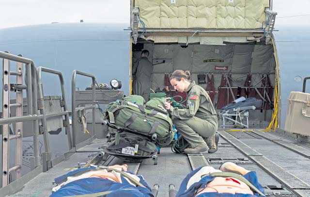 First Lt. Asha Wyatt, 86th Aeromedical Evacuation Squadron flight nurse, removes medical equipment from a bag during training. Aircrew and a KC-135 Stratotanker from Royal Air Force Mildenhall, England, spent multiple days at Ramstein performing aerial refueling missions, which also gave AES Airmen the opportunity to train on their mission inside a different airframe.