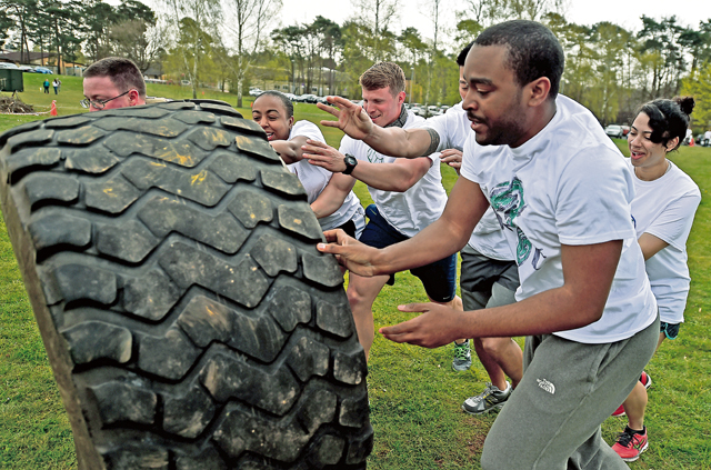 Team Respect from the 603rd Air and Space Communications Squadron, flips a tire together.
