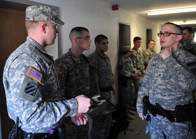 Spc. Brian Slocum (left), a military police Soldier assigned to the 21st Theater Sustainment Command’s 92nd Military Police Company, 709th Military Police Battalion, 18th Military Police Brigade and a native of Junction City, Oregon, discusses the day’s patrol route with Sgt. Kenneth S. Farrell (right) an assistant squad leader with the 92nd MP Company, April 8, on Vogelweh Militarry Complex Germany.