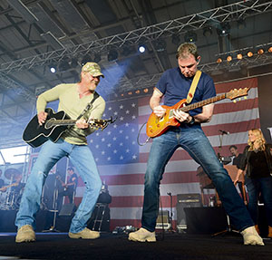 Trace Adkins jams with the lead guitarist in his band during a USO concert for members of the KMC April 20 on Ramstein.