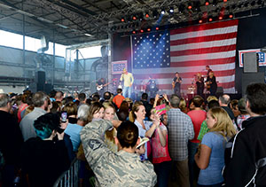 Adkins performs on a replica of the 6-foot circle of wood that sits center stage at the Grand Ole Opry in Nashville, Tenn. He is celebrating the Grand Ole Opry’s 90th anniversary during a 10-day USO tour.