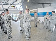 General Darren W. McDew, Air Mobility Command commander, greets Airmen from the 721st Aerial Port Squadron Ramstein Passenger Terminal March 30 on Ramstein. During his visit to Ramstein, McDew had an opportunity to experience processing a customer through the passenger terminal in addition to touring the facility
