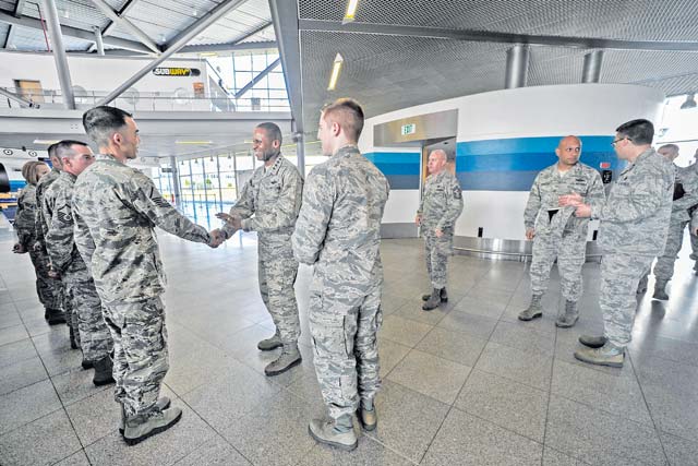 General Darren W. McDew, Air Mobility Command commander, greets Airmen from the 721st Aerial Port Squadron Ramstein Passenger Terminal March 30 on Ramstein. During his visit to Ramstein, McDew had an opportunity to experience processing a customer through the passenger terminal in addition to touring the facility