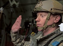 Master Sgt. Burke, 435th Contingency Response Group airfield manager, re-enlists while flying in a C-130J Super Hercules April 8, 2015 above Powidz Air Base, Poland. While deployed to Poland for training Burke re-enlisted into the Air Force on a C-130J before parachuting out.