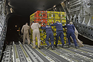 Photo by Airman 1st Class Taylor Queen Airmen and members of the U.S. Agency for International Develop-ment and the Los Angeles County Search and Rescue team, offload relief supplies for victims of the earth- quake in Katmandu, Nepal, April 28. The Air Force, members of the USAID, the Los Angeles  County Search and Rescue team and five search and rescue dogs, transported relief supplies to provide assistance to the men and women in Nepal.