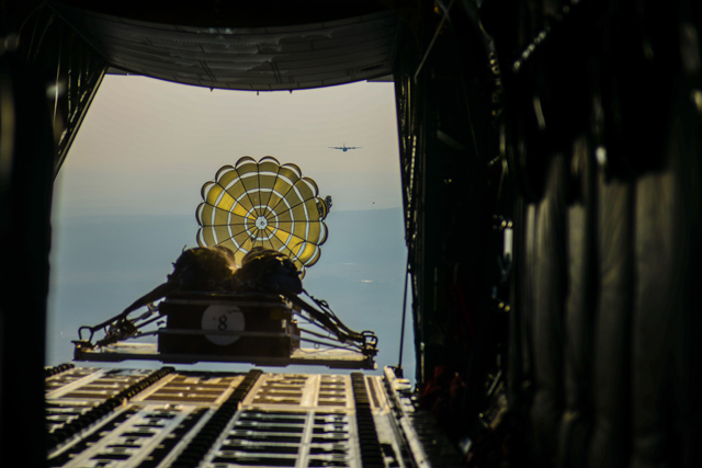 A container delivery system drops from the back of a C-130J Super Hercules aircraft during a training flight over Grafenwoehr, Germany, April 8, 2015. The CDS allowed pilots and loadmasters to practice dropping cargo from the aircraft onto a secure plot of land. (U.S. Air Force photo/Tech. Sgt. Travis Edwards)