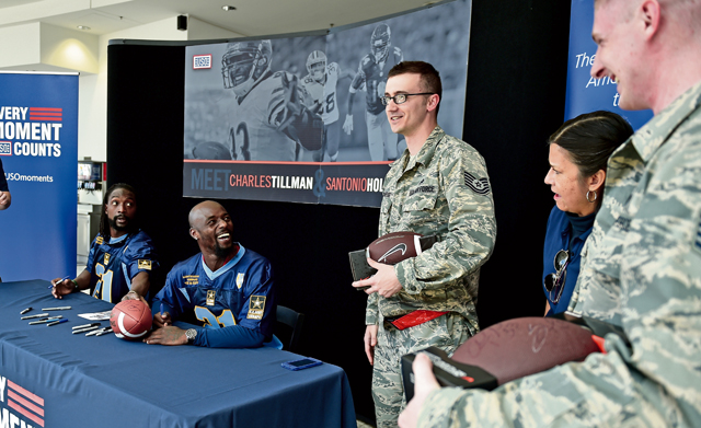  Charles Tillman, an NFL cornerback who was the Walter Payton Man of the Year in 2013, and Santonio Holmes Jr, an NFL wide receiver and MVP of Super Bowl XLIII, talk to two Airmen after signing autographs for them during the USO’s ProTour 2015. 