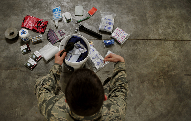 Airman 1st Class Robert Ridgway, 786th Civil Engineer Squadron plans and operations, goes through an emergency preparedness kit April 13 on Ramstein.