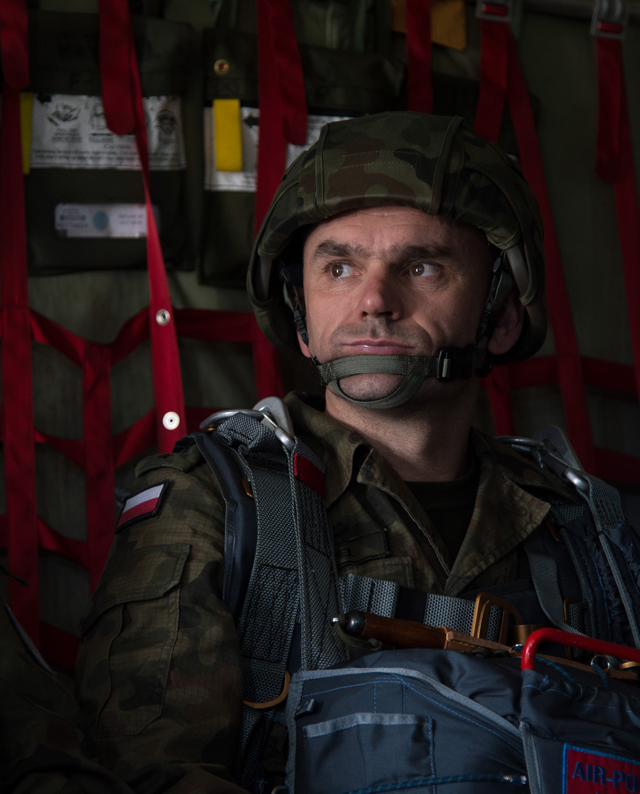 A Polish air force paratrooper waits to jump from a C-130J Super Hercules assigned to the 37th Airlift Squadron during training above Krakow, Poland. The goal of the deployment was to build and improve partnership with the Polish air force as well as interoperability for future operations.