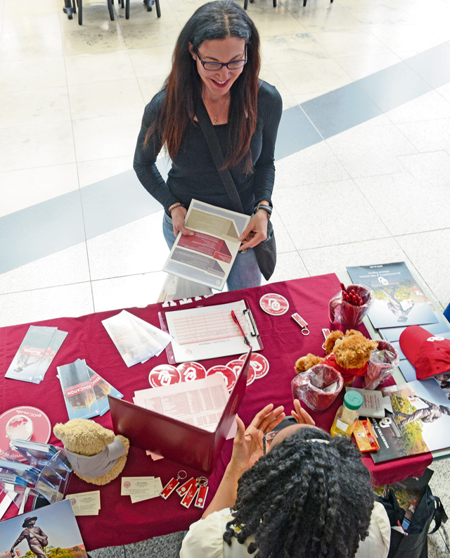 Gabriella Wells, military spouse, asks questions about education programs at the University of Oklahoma table at the 86th Force Support Squadron Ramstein Education Center Education Fair, held at the Kaiserslautern Military Community Center food court at Ramstein Air Base, Germany, April 16, 2015. Wells heard about the fair on the radio and came to find out more information about pursuing an advanced degree in strategic communication. 