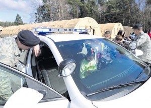 Members from the 86th Security Forces Squadron give Ramstein Intermediate School students a tour of their patrol vehicle during a mock pre-deployment line. 