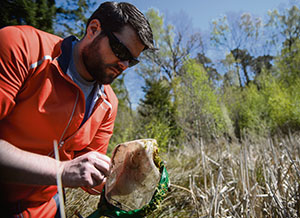 Photos by Staff Sgt. Armando A. Schwier-Morales Joshua Lee, 86th Civil Engineer Squadron environmental management intern, looks for amphibians in a net, April 22 on Ramstein. Lee helped conduct an amphibian survey to ensure the base has an accurate picture of the species within the fenceline.