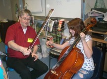 Hans Naßhorn from the Kaiserslautern Orchestra visited Sharon Emerling's fifth-grade classroom at Landstuhl Elementary Middle School and allowed Elizabeth White to play his instrument.
