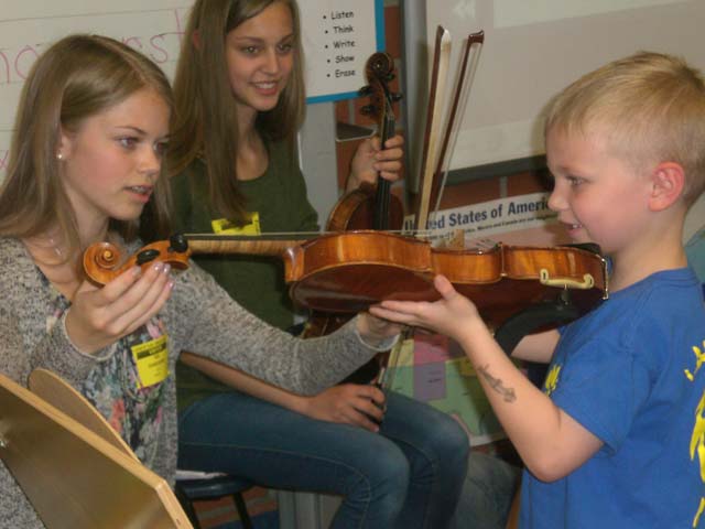 After the concert, Ida Ohnesorg and Lara Marie Missal from the Kaiserslautern Orchestra, visited Julie Wittenberg's first-grade classroom at Landstuhl Elementary Middle School and allowed Bridger Lake to play the violin.