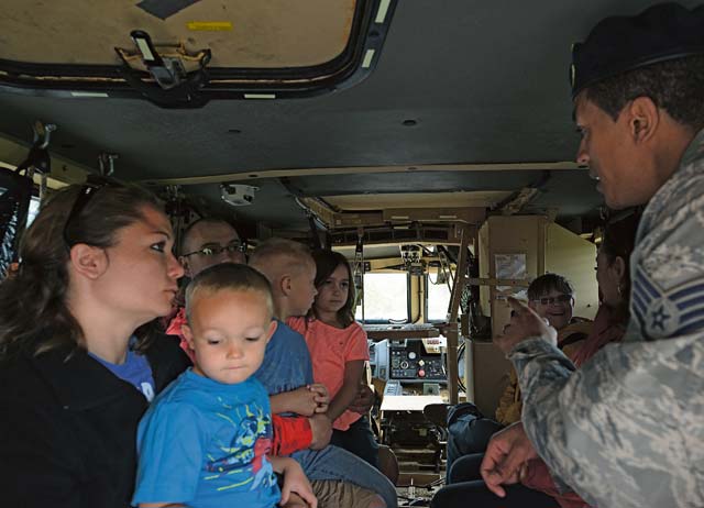 Staff Sgt. Ritchie Brown, 435th Security Forces Squadron instructor, educates members of the KMC about the mine-resistant, ambush-protected vehicle during a display for National Police Week. Patrons were also able to enter police cars and play the sirens during the event.