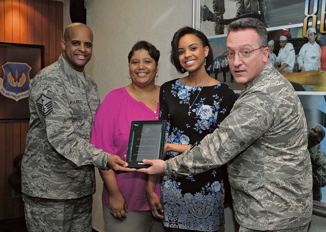 Photo by Senior Airman Timothy Moore RianSimone Harris receives the 2015 European Military Youth of the Year award from Brig. Gen. Patrick X. Mordente, 86th Airlift Wing commander, March 30 on Ramstein. Pictured with Harris are her parents Tatineesha and Master Sgt. Shaun Harris, 435th Security Forces Squadron first sergeant.