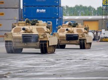 Photo by Staff Sgt. Warren W. Wright Jr. 
Two M1 Abrams tanks move down the docks of Antwerp toward their holding area after being offloaded from the freighter “Resolve,” April 24.