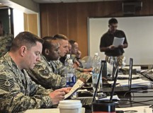 Airmen look at their course handouts as Michael DeJacomo, a mobile training team instructor with the 312th Training Squadron, conducts a lecture during a Fire Officer III certification course May 13 on Ramstein. Eighteen firefighters from across U.S. Air Forces in Europe gathered for the 10-day advanced fire protection course which began May 4.