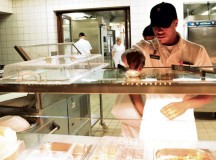 Spc. Myles F. Gooden, a food service specialist assigned to the 21st Theater Sustainment Command’s Headquarters and Headquarters Company, 30th Medical Brigade, prepares the serving line during the Philip A. Connelly Awards Program evaluation April 29 at the Clock Tower Cafe on Kleber Kaserne.
