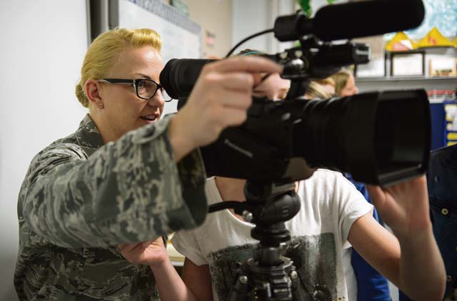 Senior Airman Lindy Pata, American Forces Network Kaiserslautern broadcaster, teaches children from Ramstein Intermediate School about her career April 28 on Ramstein. 
