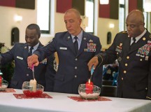U.S. Air Force and Army service members light a candle to honor the memories of deceased children during the Kindergraves memorial service May 16 in Kaiserslautern. Representatives from Ramstein and the host nation serve as co-chairs for the Kaiserslautern Kindergraves Memorial Foundation which maintains open communication with families, preserves historical archives, conducts ceremonies and provides oversight to site maintenance.