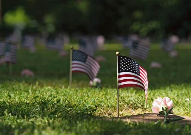 U.S. flags were placed next to grave stones during the Kindergraves memorial service May 16 in Kaiserslautern. Children buried here were no more than 12 months old during 1951 to 1971. Most died of various childhood diseases or birth complications.