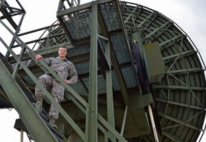 Senior Airman Ryan Pastor, 460th Space Communications Squadron radio frequency transmissions system journeyman, stands beside a radio dish May 4 on Ramstein.