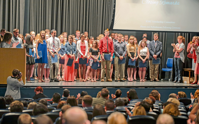 Graduating high school students stand for photos after receiving their scholarships for higher education May 17 on Ramstein.