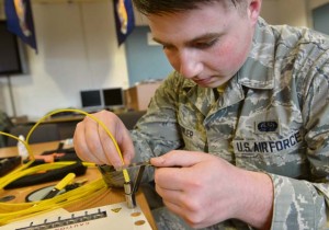 Airman 1st Class Dillon Fowler, 86th Communications Squadron cable and maintenance technician, slides fiber optics into an epoxy connector to create an end-to-end path April 30 on Ramstein. 