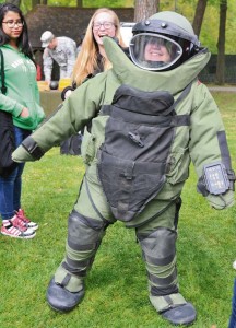 A student climbs into a hazardous materials suit used by the Explosive Ordnance Disposal Company, 18th Combat Sustainment Command, during Operation Spirit.